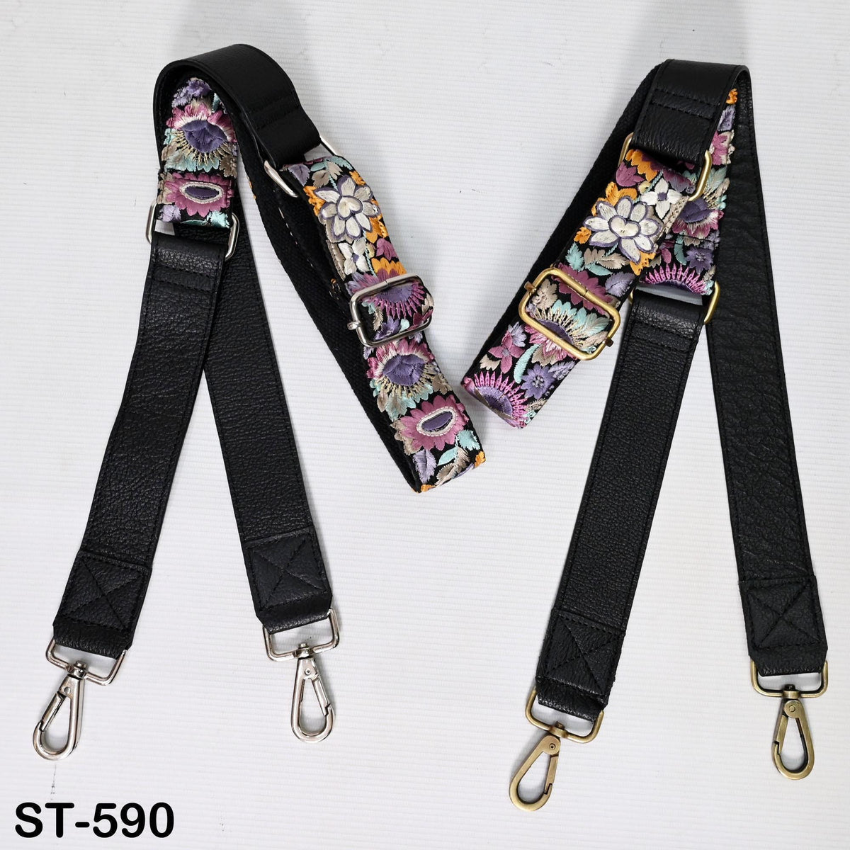 two black leather straps with floral patterns, each with metal hooks and buckles. The straps appear to be made of high-quality leather and are designed for use as crossbody straps.