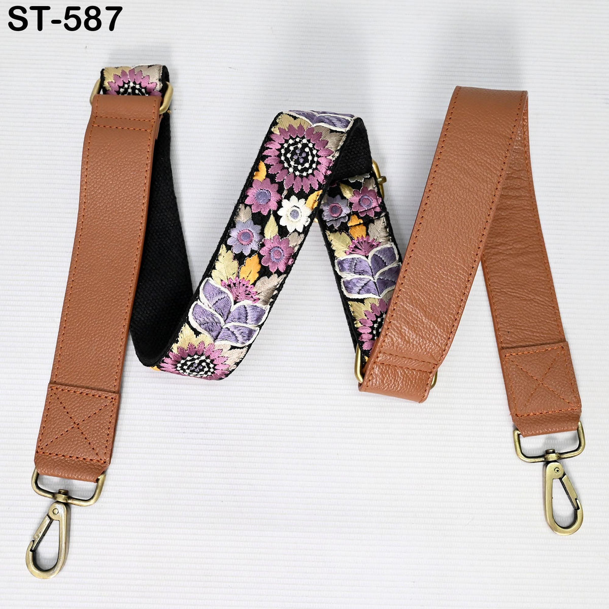 A floral patterned leather strap with a metal hook attached, displayed on a white background.