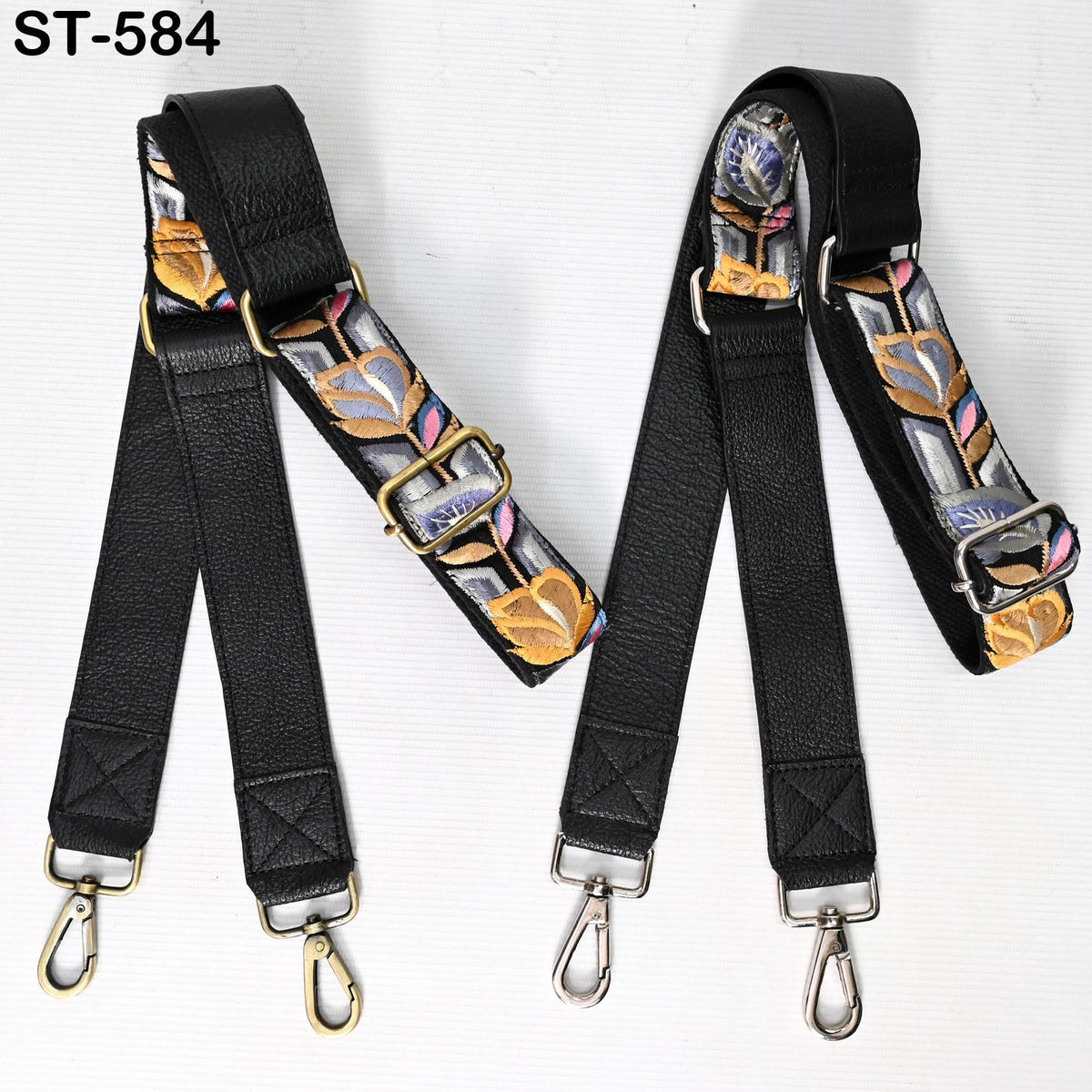 two black leather straps with metal buckles and hooks, each with a floral pattern on the fabric. The straps appear to be made of high-quality leather material and are designed for use as crossbody straps.