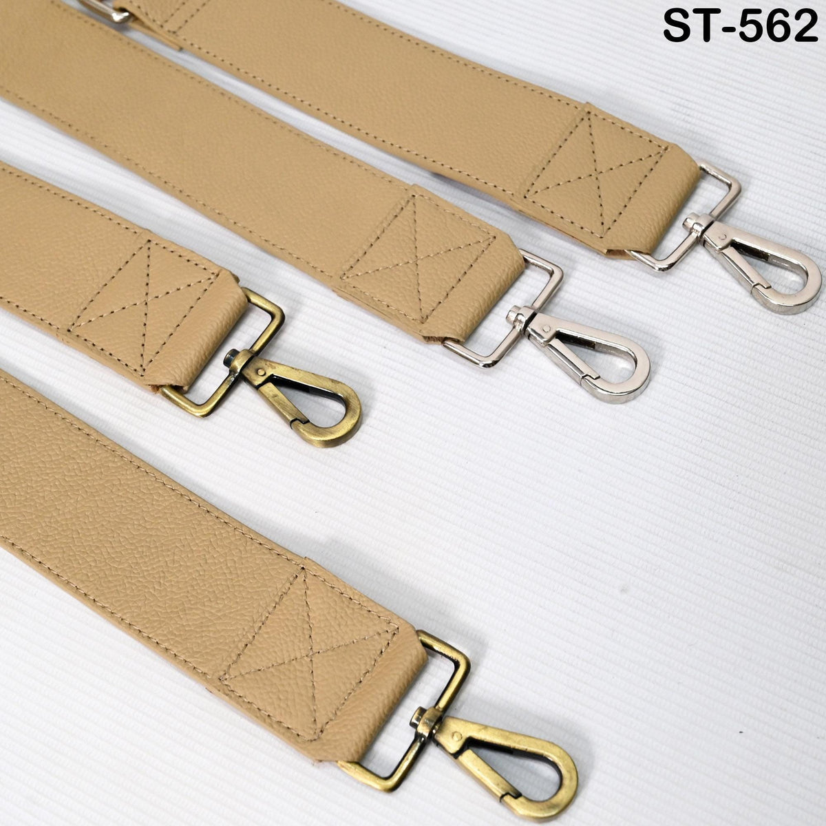 a collection of tan leather straps with metal hooks, arranged on a white background.