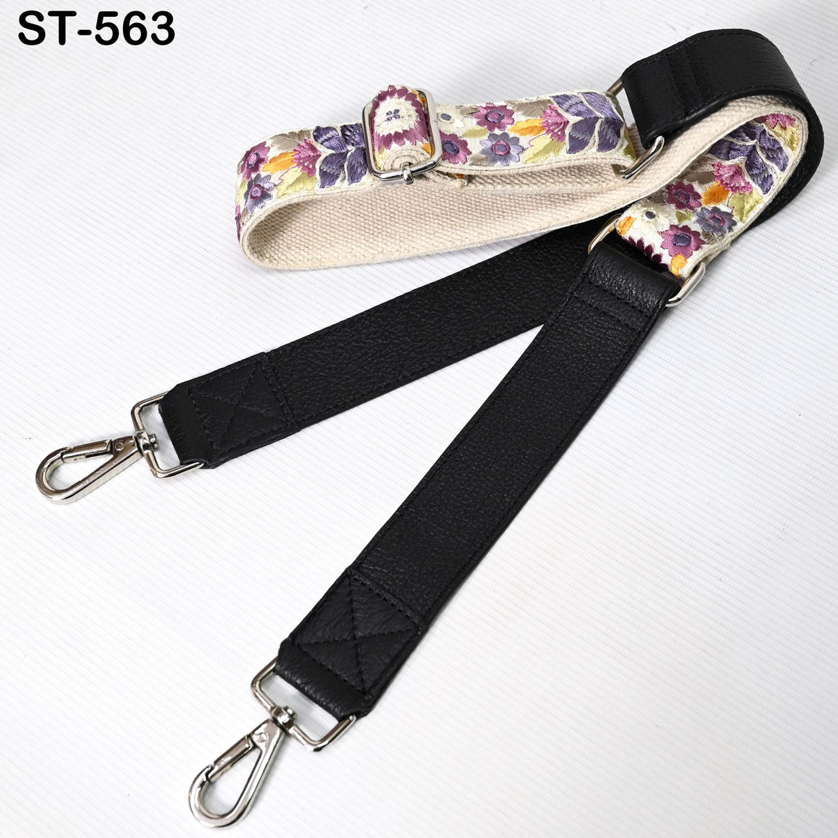 a black leather strap with a floral pattern, which appears to be a strap or strap accessory.