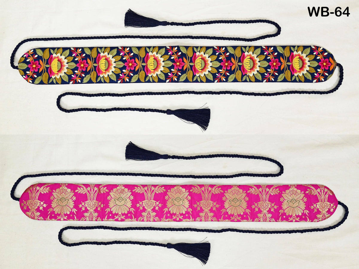 two decorative fabric items with floral patterns. The item on the left is a long, narrow fabric with a floral design in shades of blue and green, while the item on the right is a long, narrow fabric with a pink floral design. Both items have tassels attached to them.