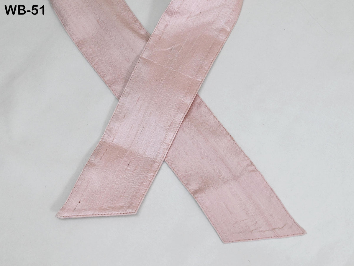 A pink satin ribbon is shown against a white background.
