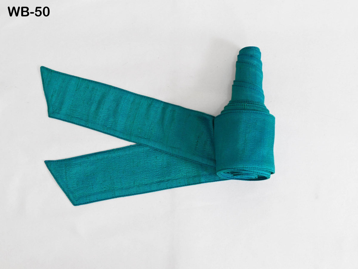 A rolled-up turquoise fabric with a pointed end is displayed against a white background.