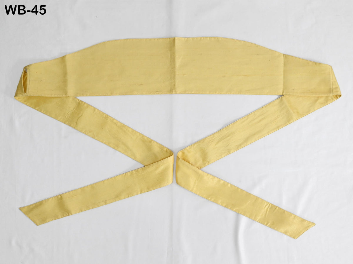 a yellow fabric item, possibly a scarf or a belt, with a white background.