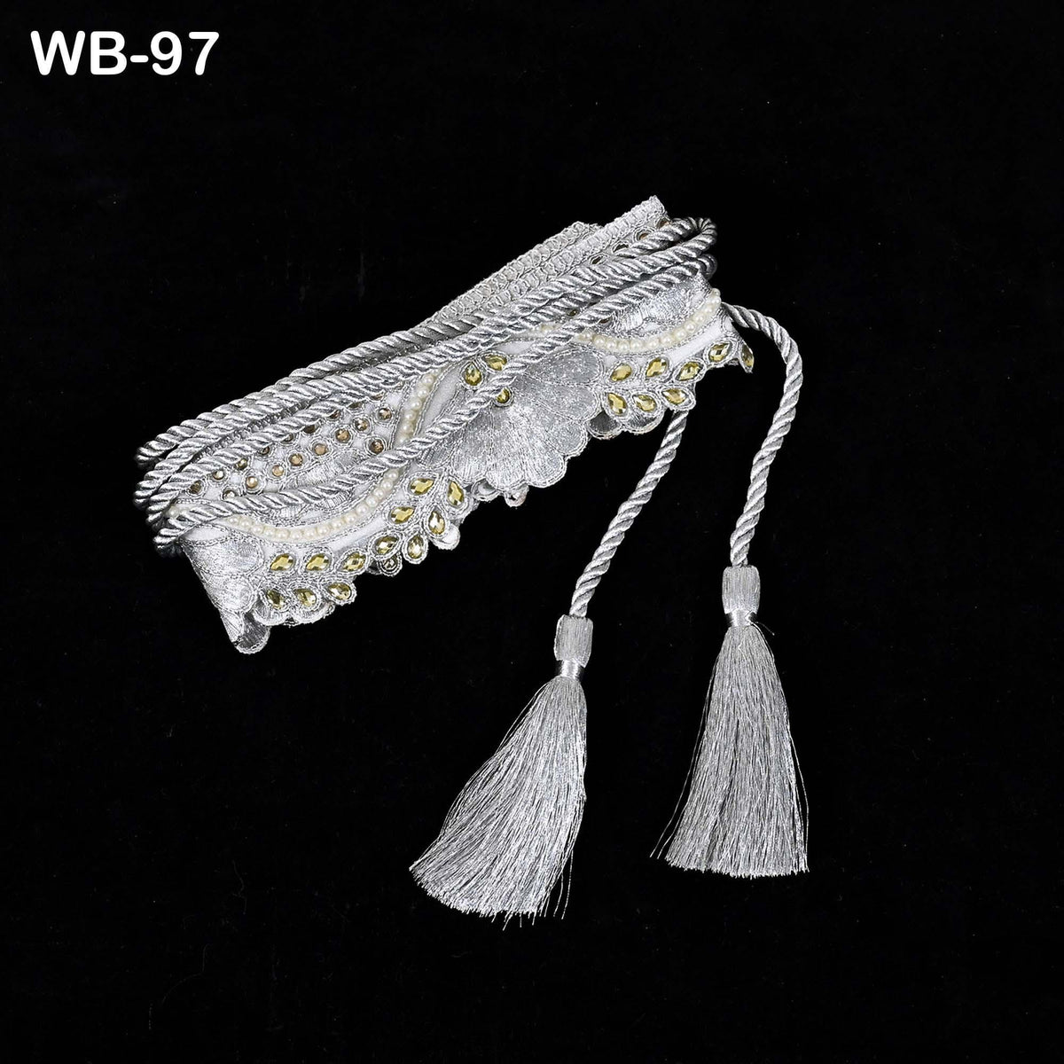 A decorative silver tassel with tassels attached to it, displayed against a black background.