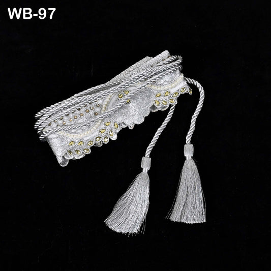 A decorative silver tassel with tassels attached to it, displayed against a black background.