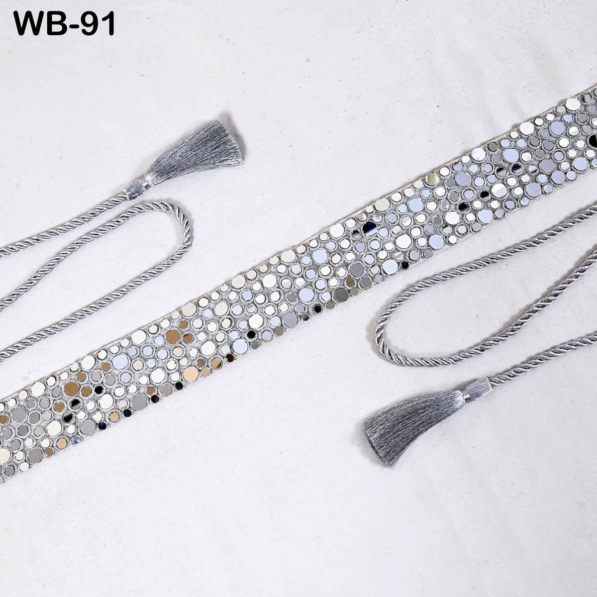 a silver belt with a tassel on a white background.