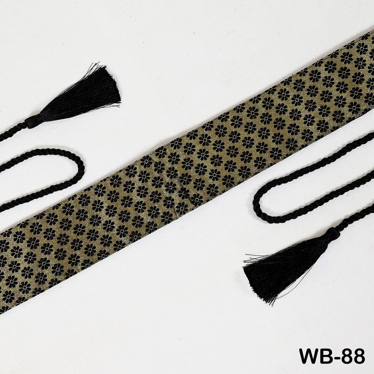 a tie with a floral pattern and two black tassels, one on each side, against a white background.