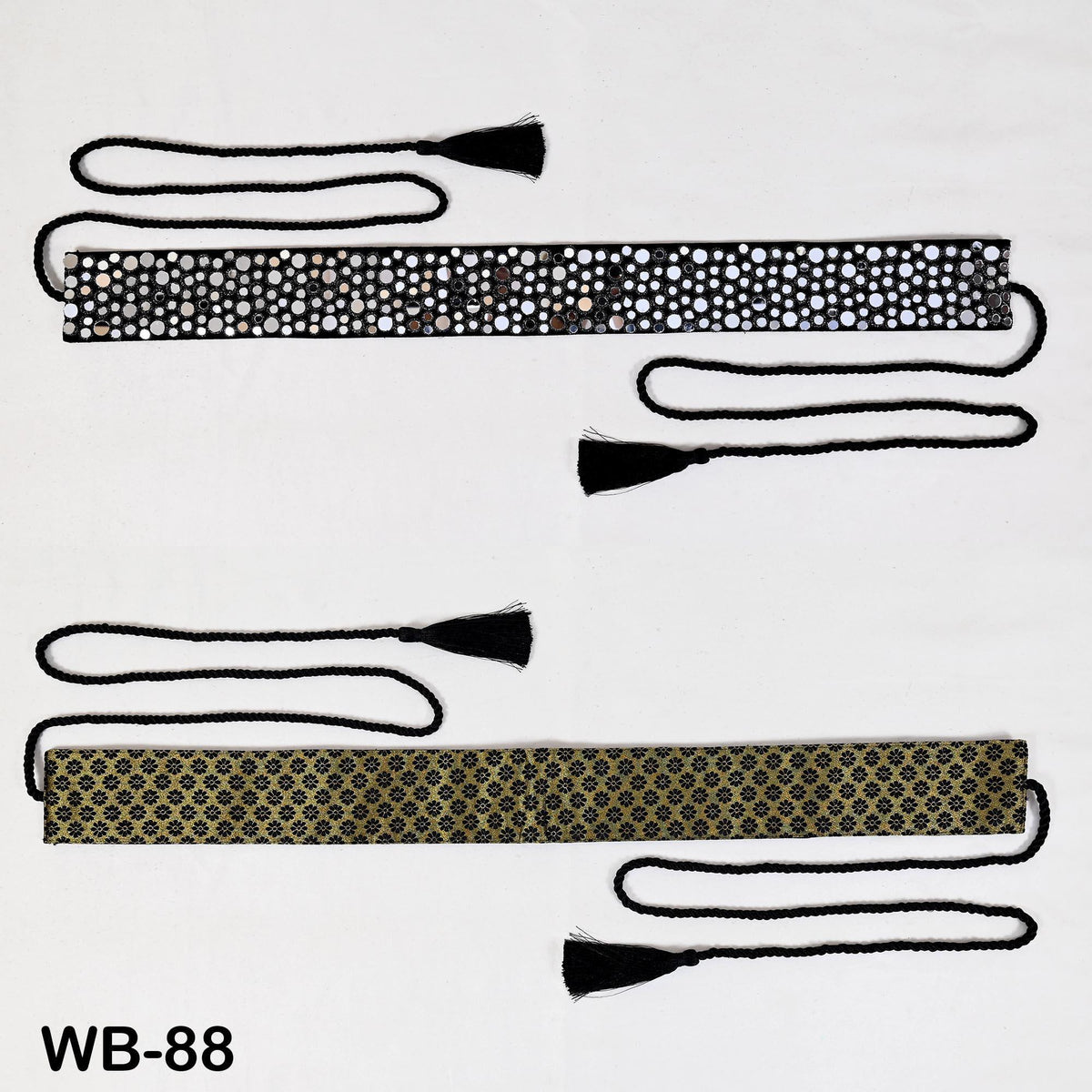 two decorative belts with tassels, one with a black and white polka dot pattern and the other with a gold and black pattern.