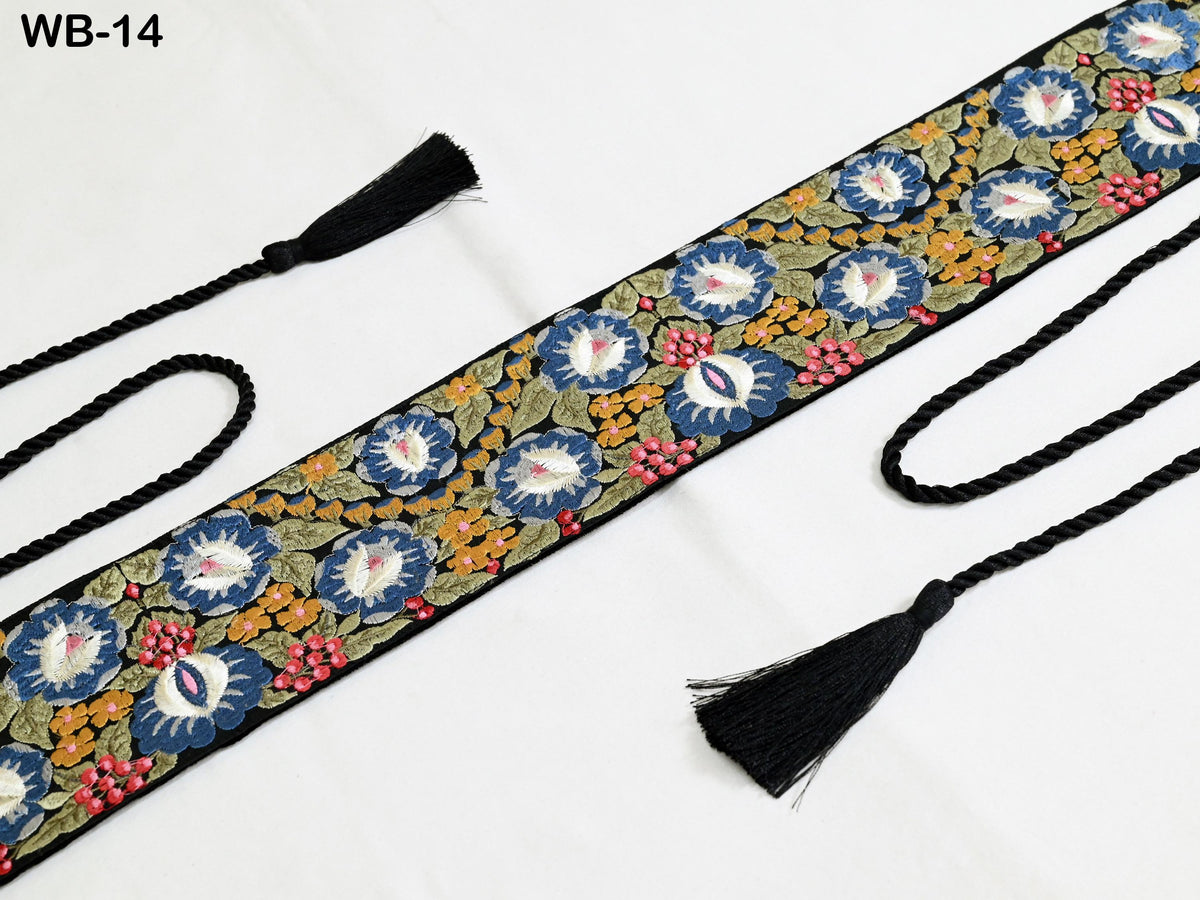 a decorative fabric with a floral pattern and black tassels.