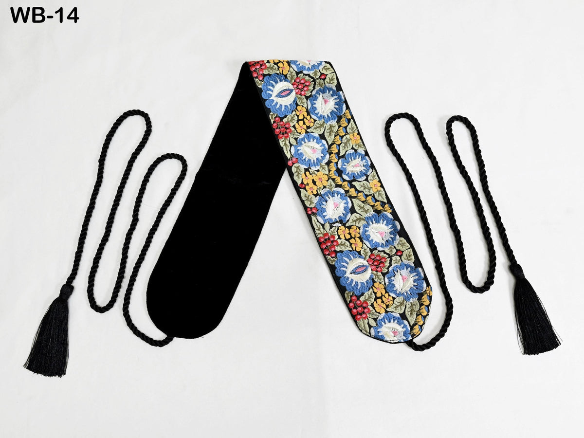 a decorative scarf with a floral pattern and black tassels.