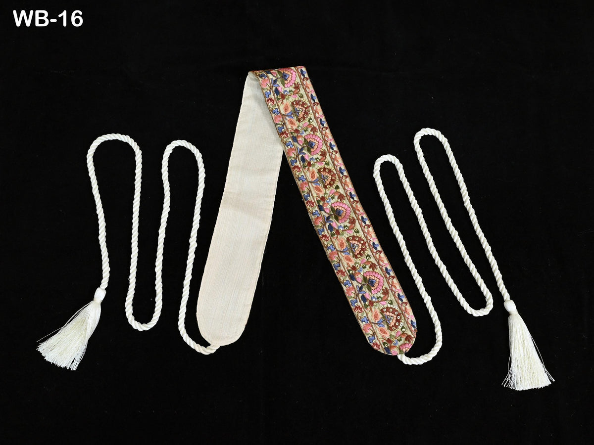 a decorative tie with a floral pattern, placed on a black background.