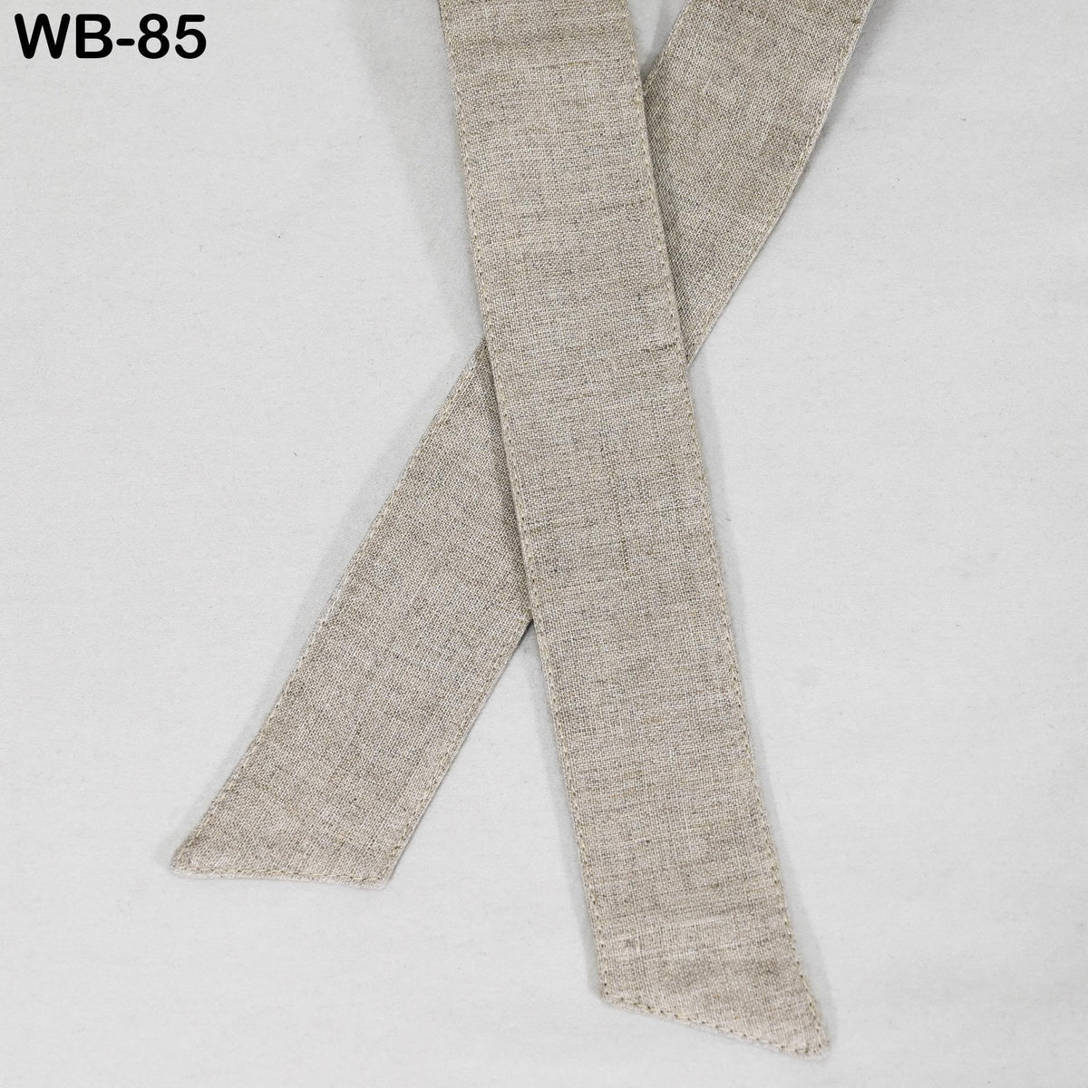 A beige fabric item, possibly a scarf or a tie, is shown in the image.