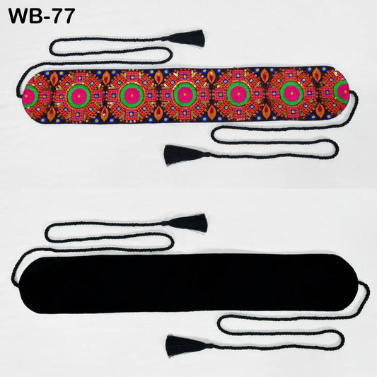 a colorful, patterned fabric with a black tassel attached to it.