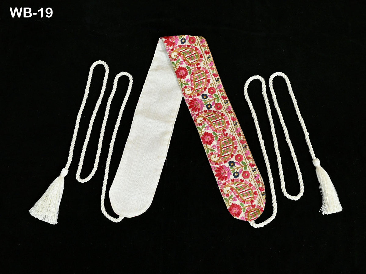 a pair of decorative sash or scarf with a floral pattern, placed on a black background.