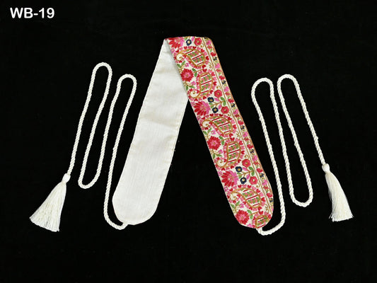 a pair of decorative sash or scarf with a floral pattern, placed on a black background.