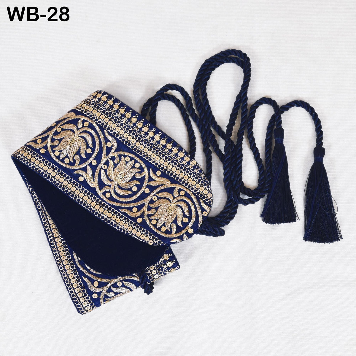 a decorative blue and gold fabric with intricate embroidered patterns, including tassels and a tassel chain.