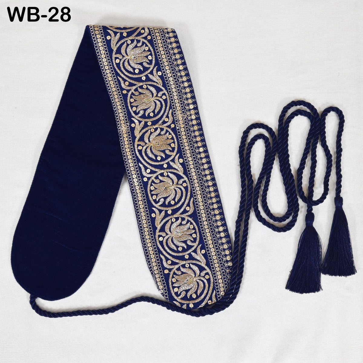a decorative blue and gold sash or scarf with intricate embroidered patterns, placed on a white background.