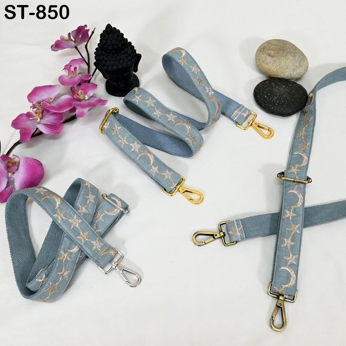 a collection of accessories, including star-patterned straps and a black statue, arranged on a white background.
