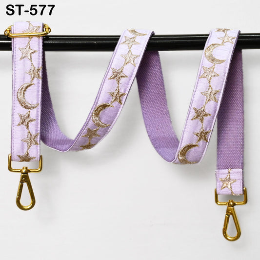 A purple strap with gold star and crescent designs, attached to a black metal hook.