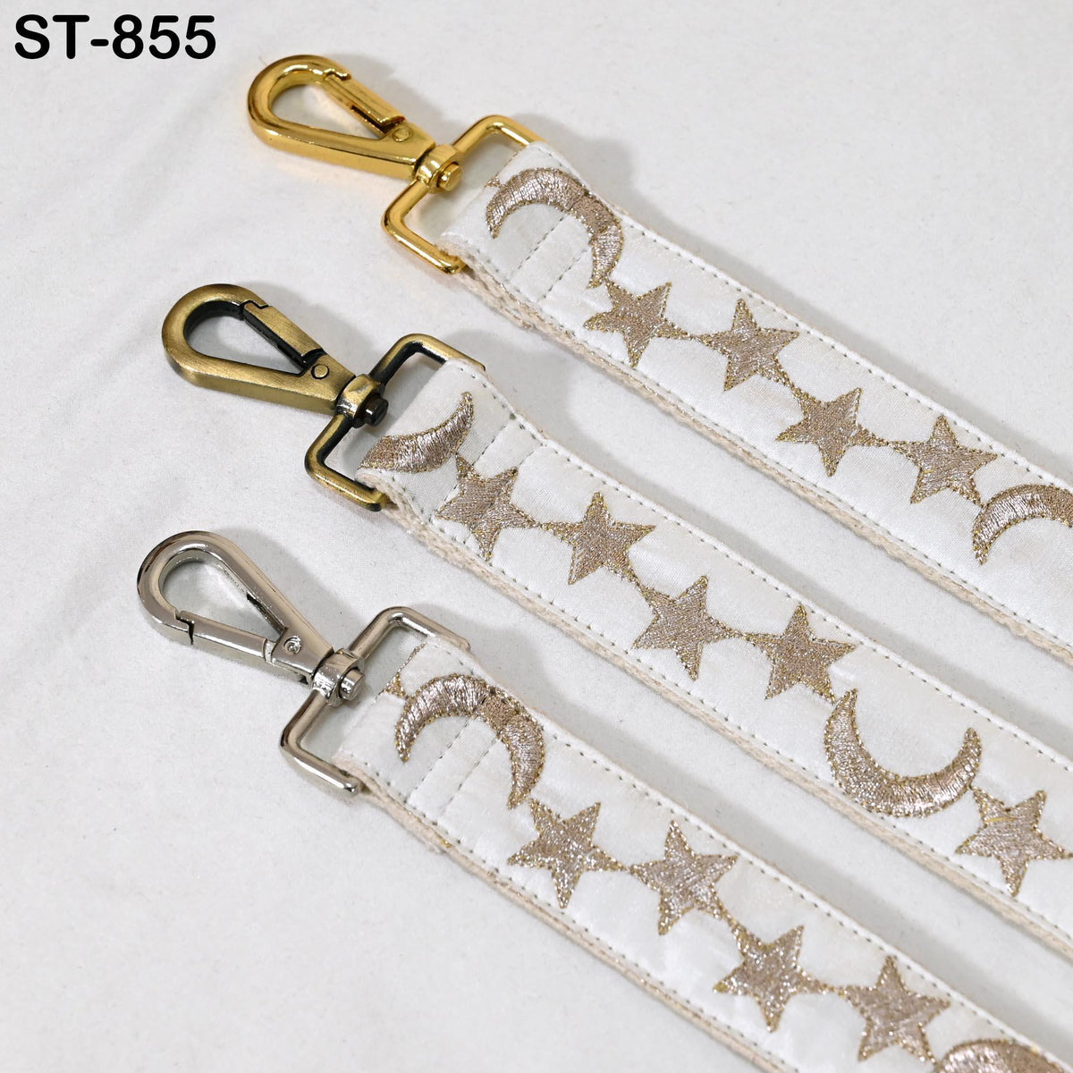 three straps with metallic buckles and star patterns, arranged in a row.