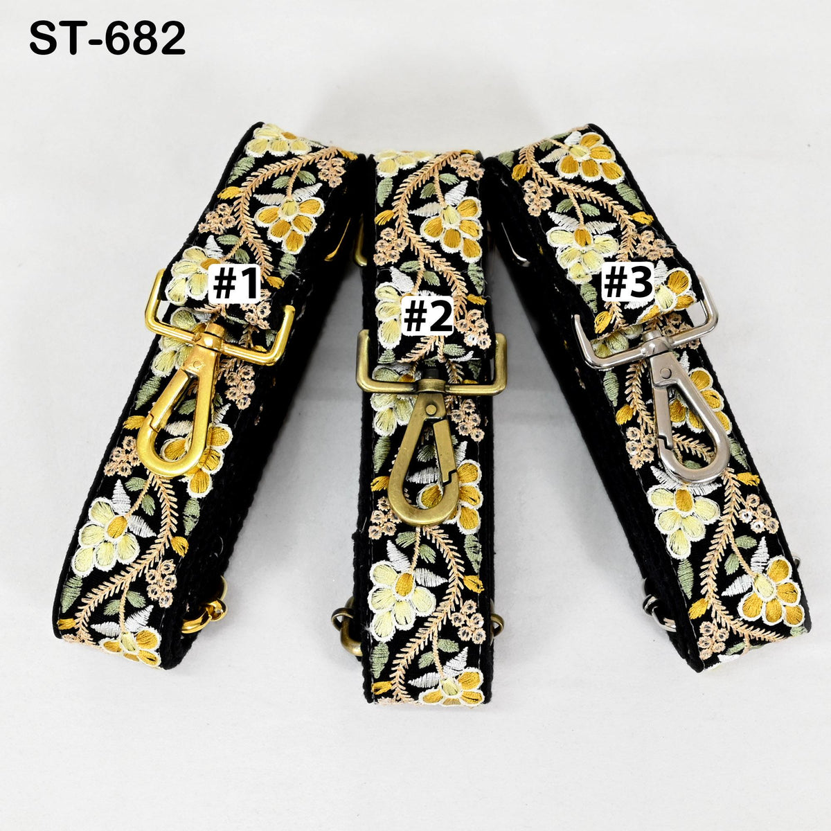 Three black straps with gold floral embroidery, each with a gold clasp and labeled with a number (1, 2, 3).