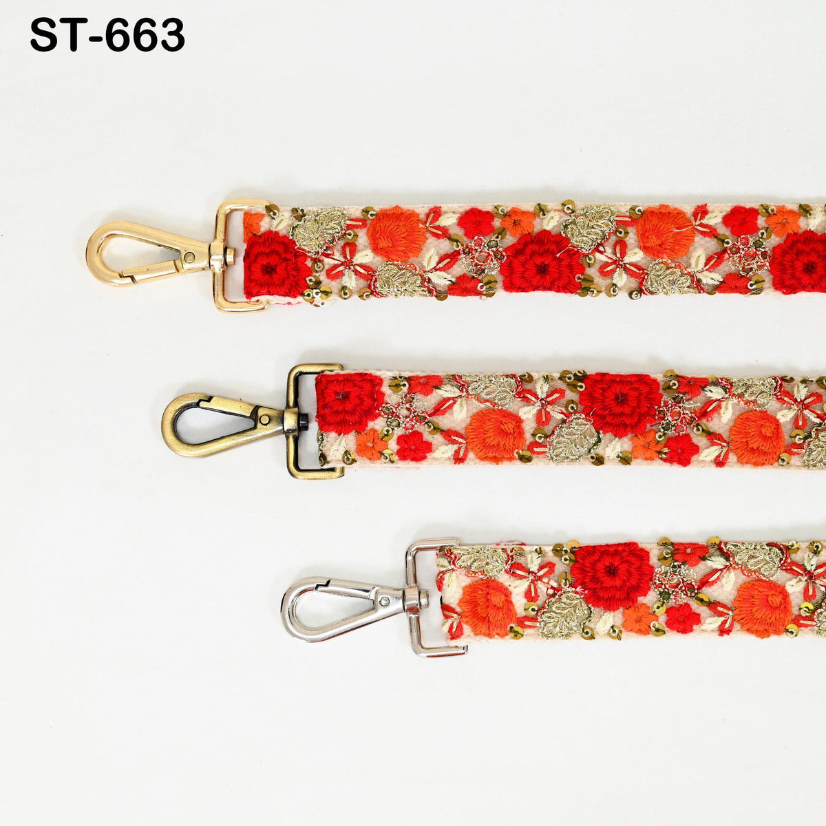 three straps with floral embroidery in red, orange, and gold colors. The straps have metal hooks and appear to be made of a shiny material.