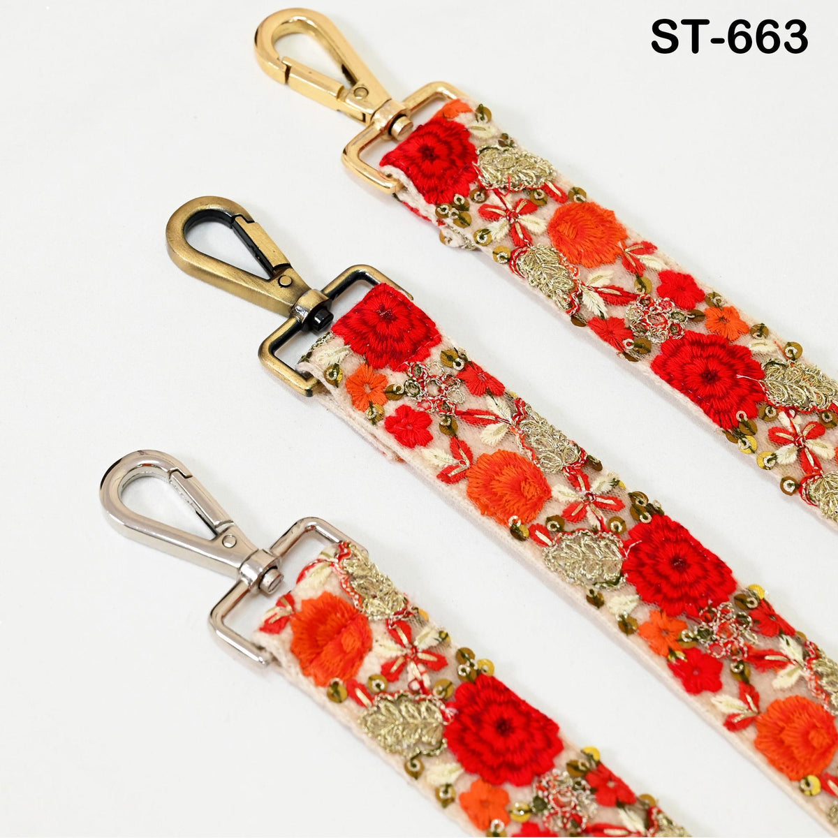 three straps with floral embroidery and metal hooks, arranged side by side.