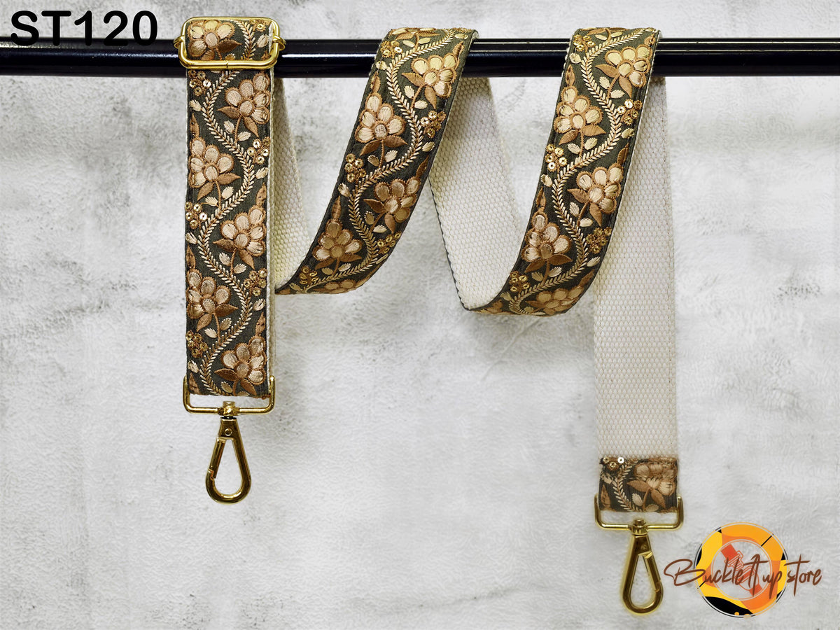 A floral-patterned strap with a metal hook attached, hanging on a black rod.