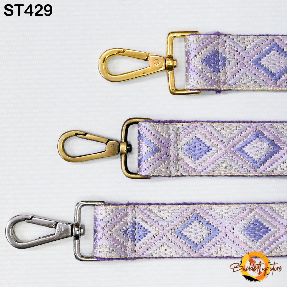 three different straps with metal hooks and buckles, arranged in a row.