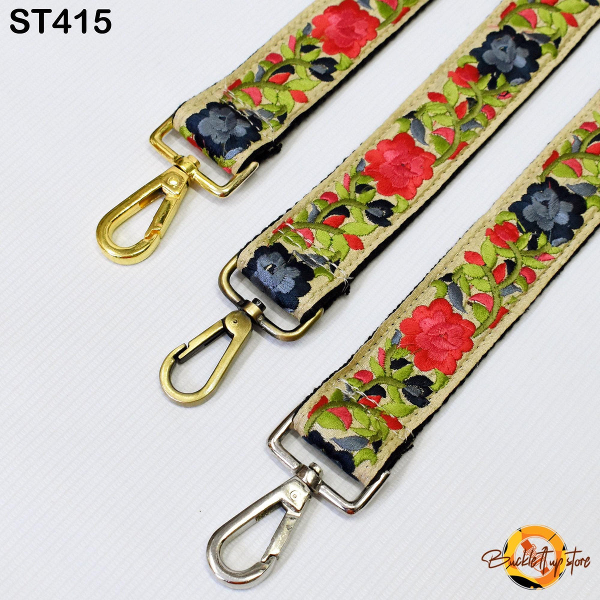 three colorful straps with floral patterns, each featuring a metal clasp and a gold-colored metal loop.