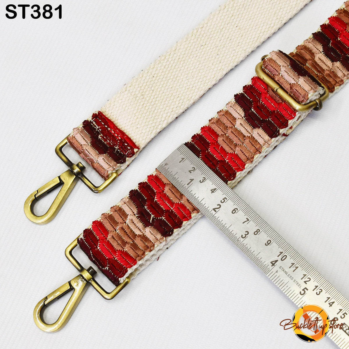 a strap with a metal ruler placed on top of it, indicating the strap's length.