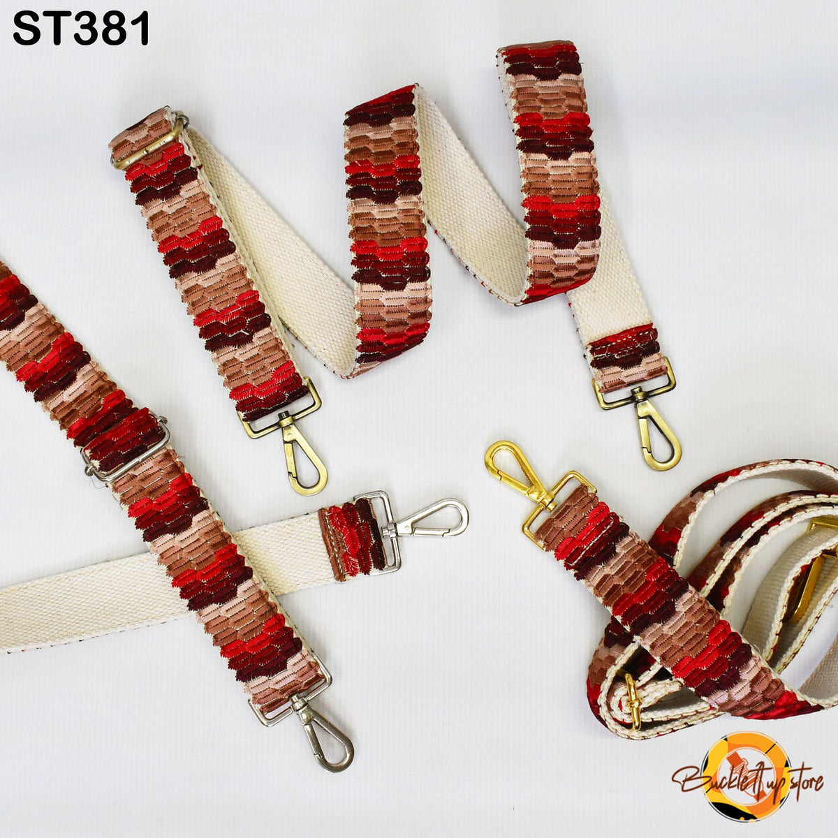 a collection of colorful, patterned straps and buckles, including a white strap with red and brown stripes and a gold-colored strap with a red and brown striped pattern.