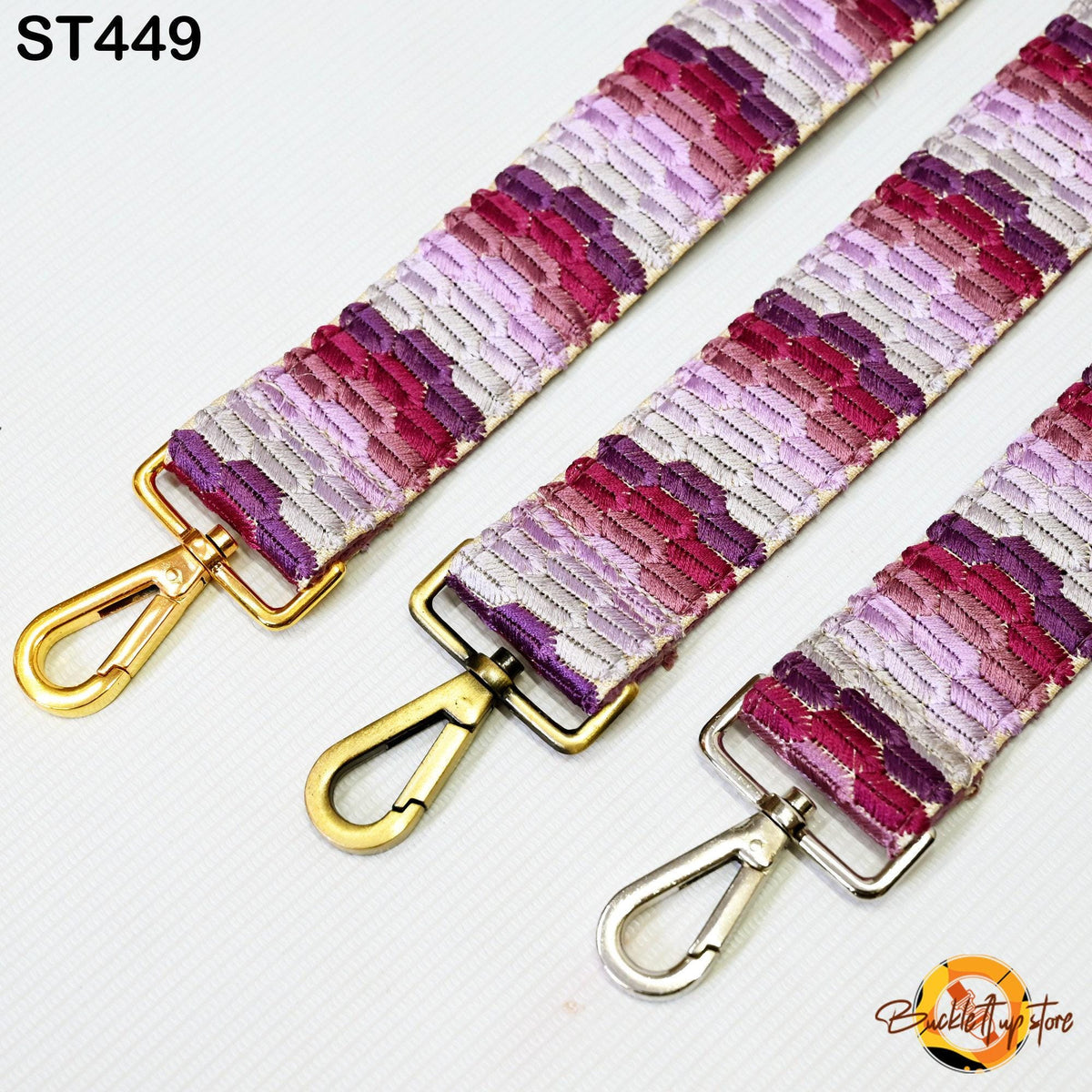 three colorful straps with gold and silver metal hooks, arranged side by side.