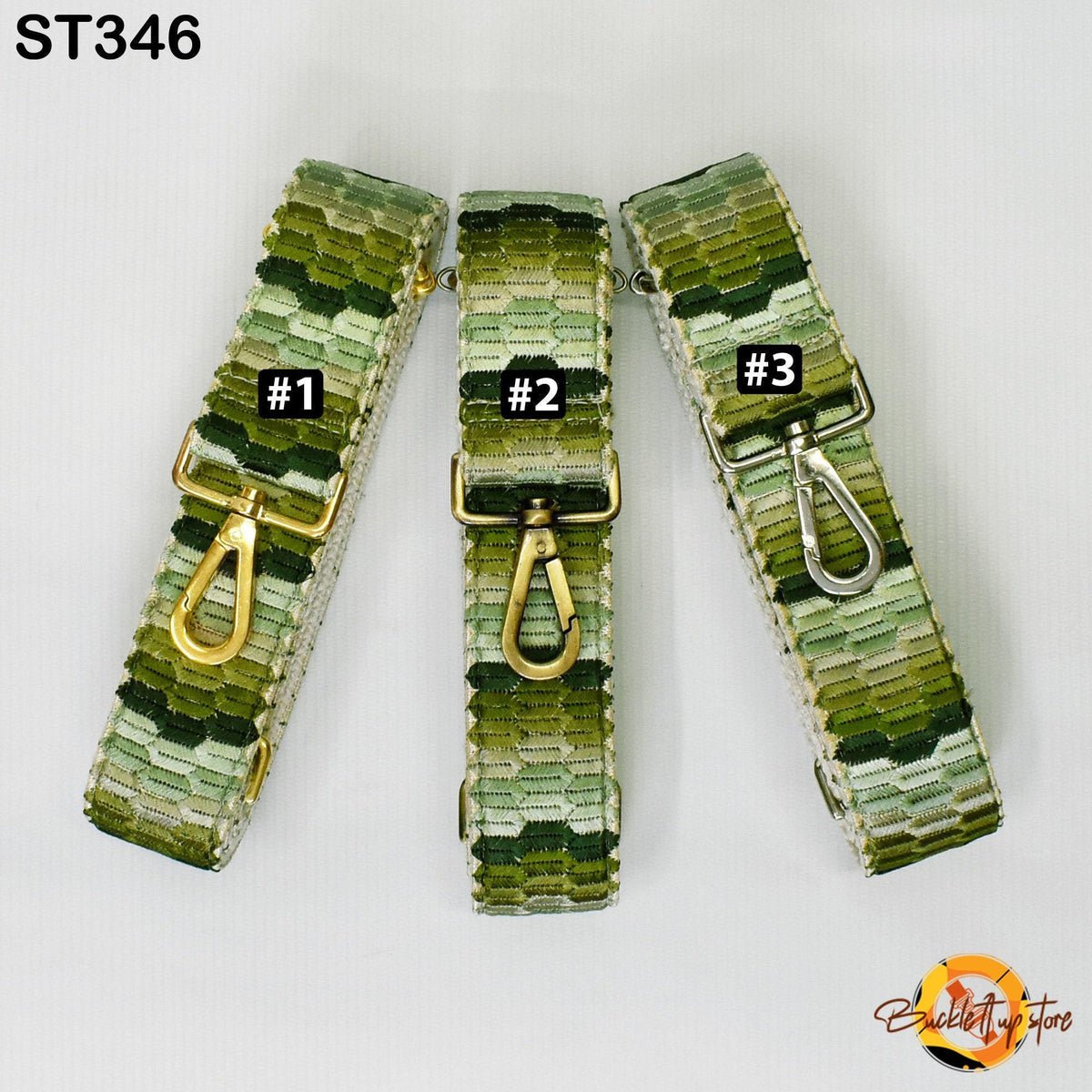 three green and gold patterned straps, each with a metal clasp and hook, arranged in a row.