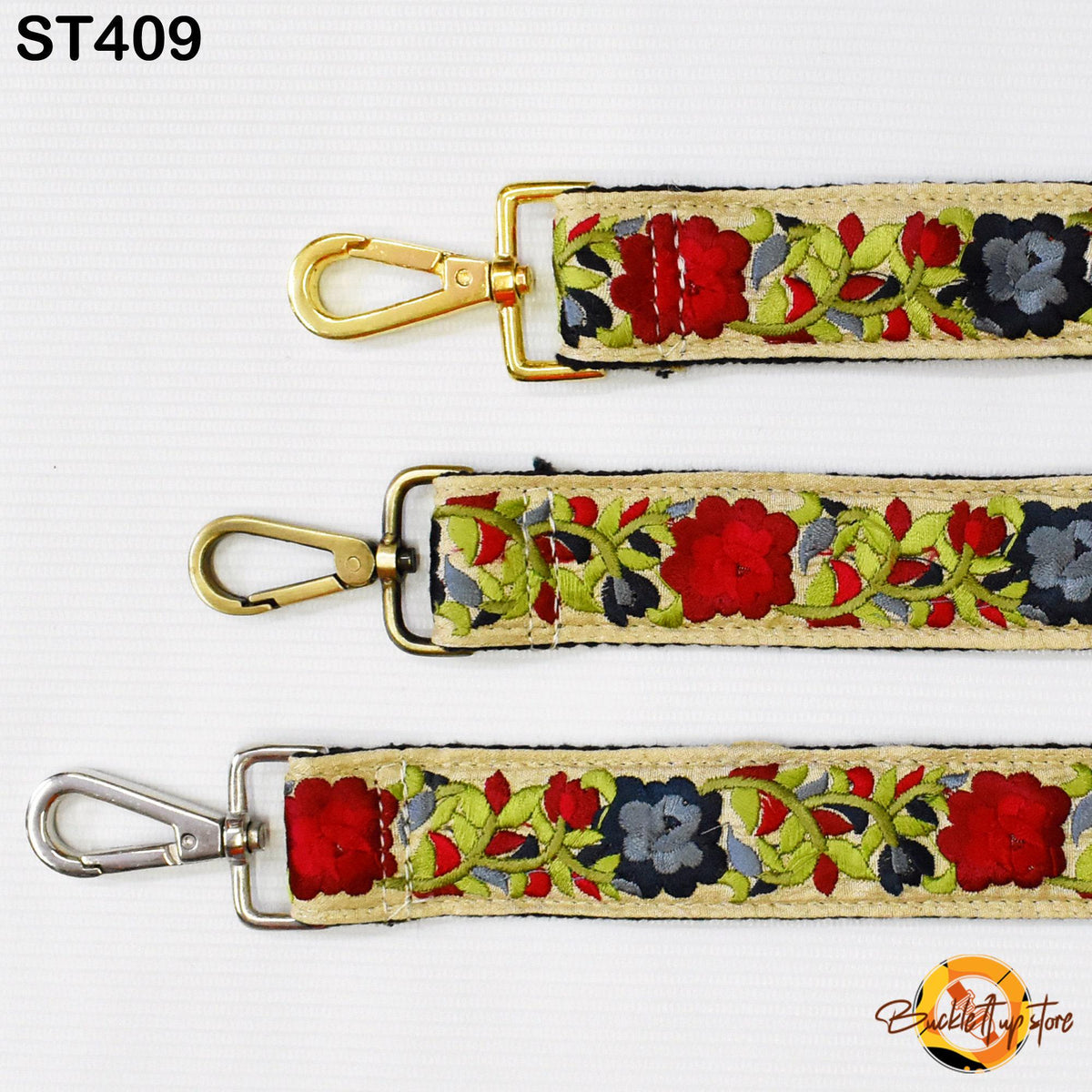 three different straps with floral patterns in red, green, and blue colors. The straps have metal hooks and are arranged in a row, showcasing their design and color variations.