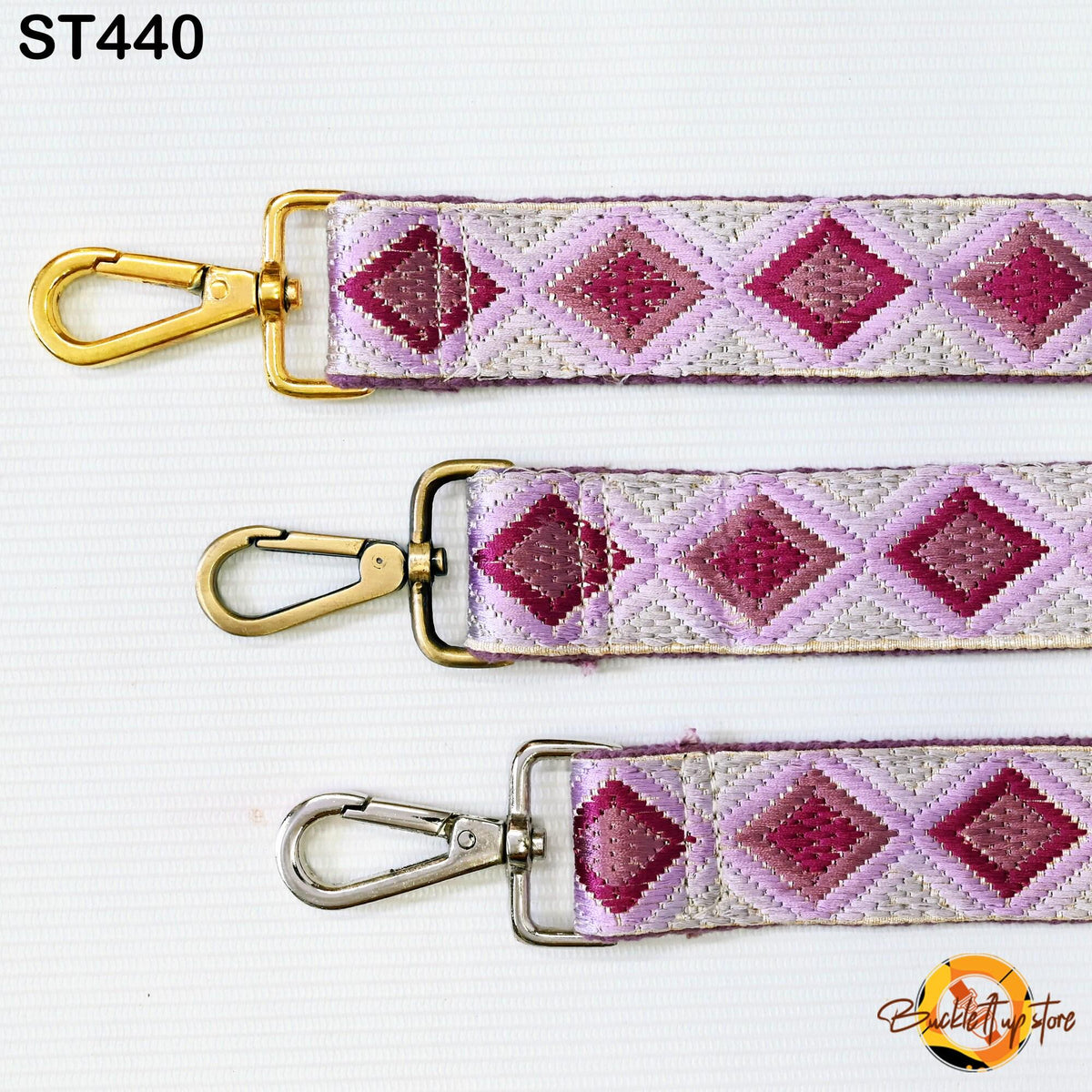 three colorful straps with gold and silver metal hooks, arranged in a row on a white background.