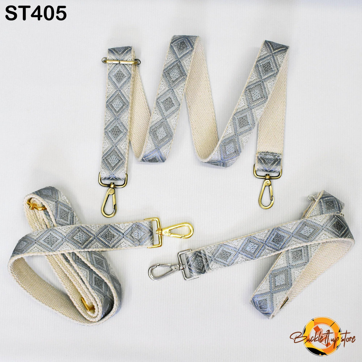 a set of gray and white patterned straps with metal hooks, arranged on a white background.
