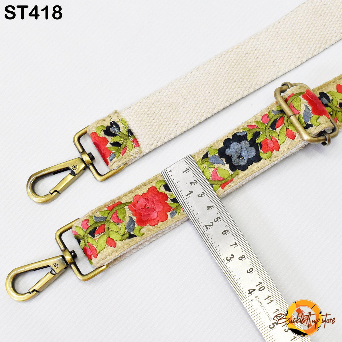 a strap with a floral pattern, and a ruler is placed next to it, indicating the strap's length.