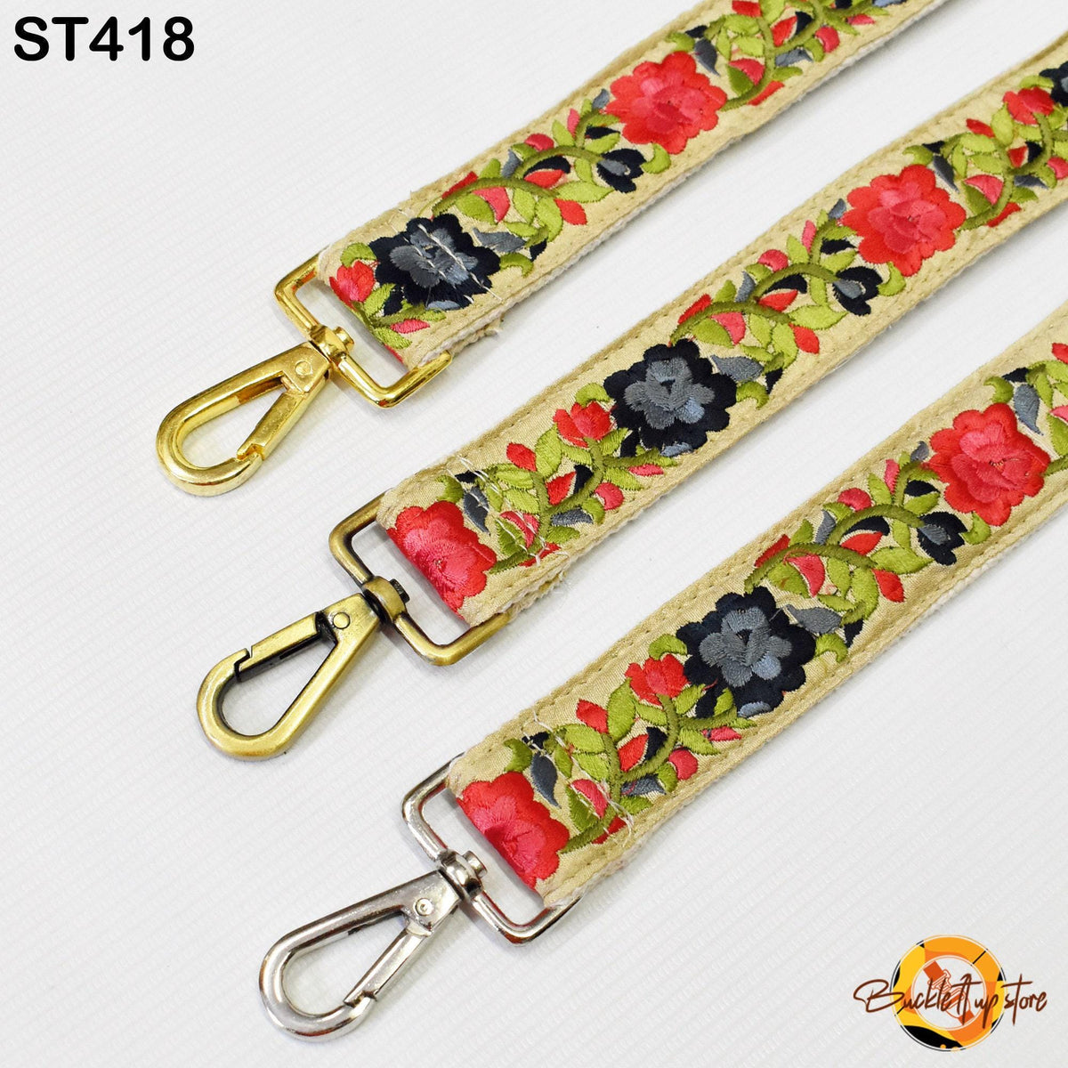 three straps with floral embroidery in red, black, and green colors. The straps have gold metal hooks and are arranged in a row.