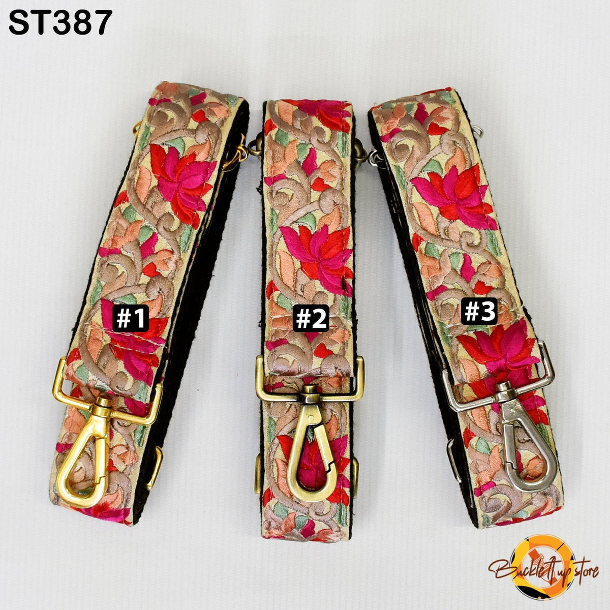 Three colorful floral straps with gold buckles, each with a different number printed on it.