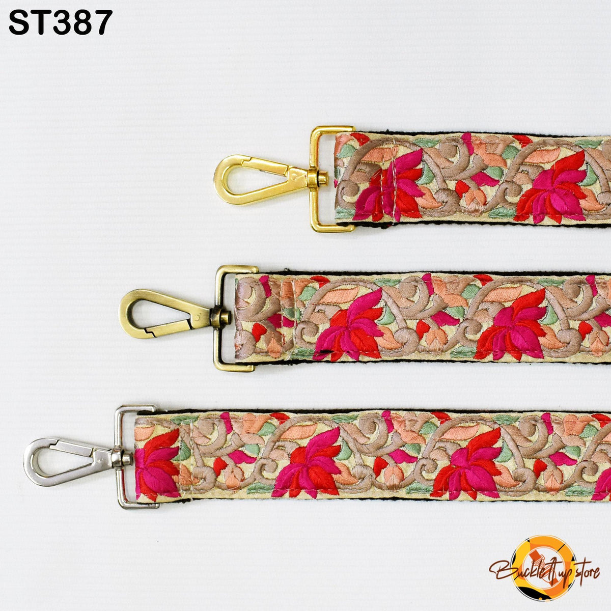 three straps with floral patterns in red, pink, and green colors. The straps have gold buckles and hooks, and they are arranged in a row on a white background.