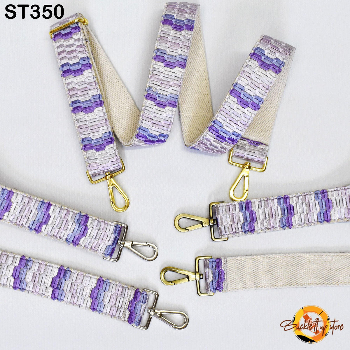 a collection of colorful straps with gold metal hardware, including buckles and clips, arranged on a white background.