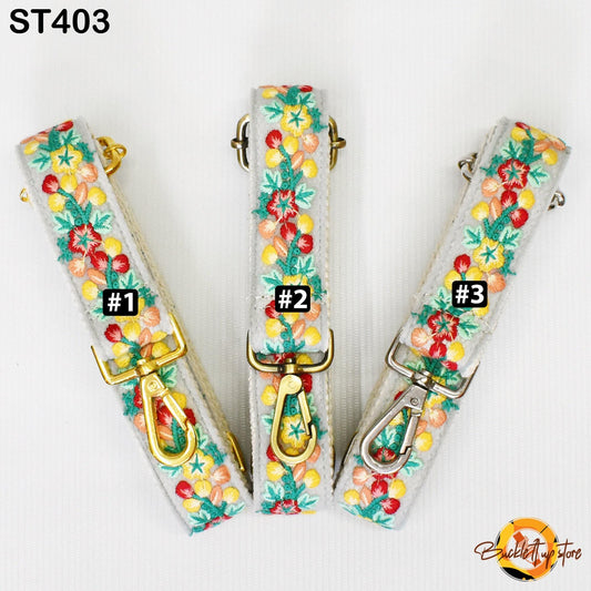 three colorful straps with floral patterns, each with a different number attached to it.