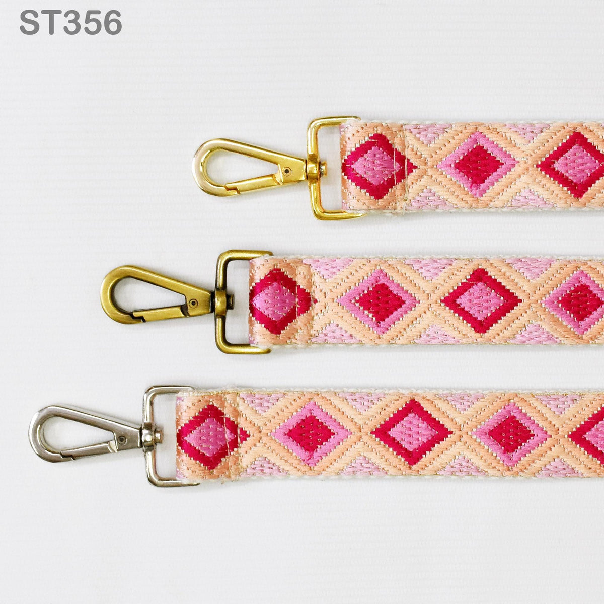 three colorful straps with gold metal clasps and a geometric pattern in shades of pink and orange.