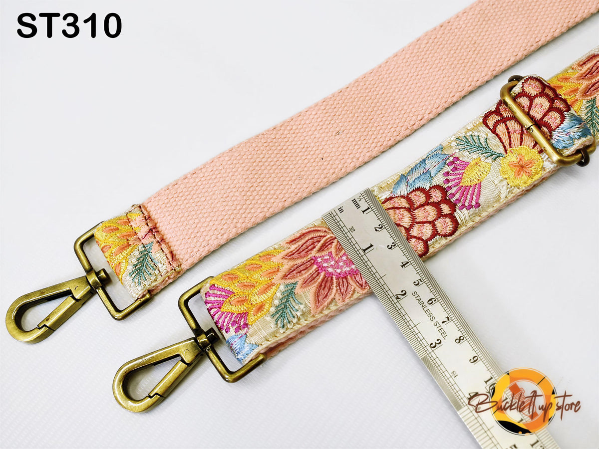 a pink strap with a floral pattern, and a ruler is placed next to it, indicating the strap's length.