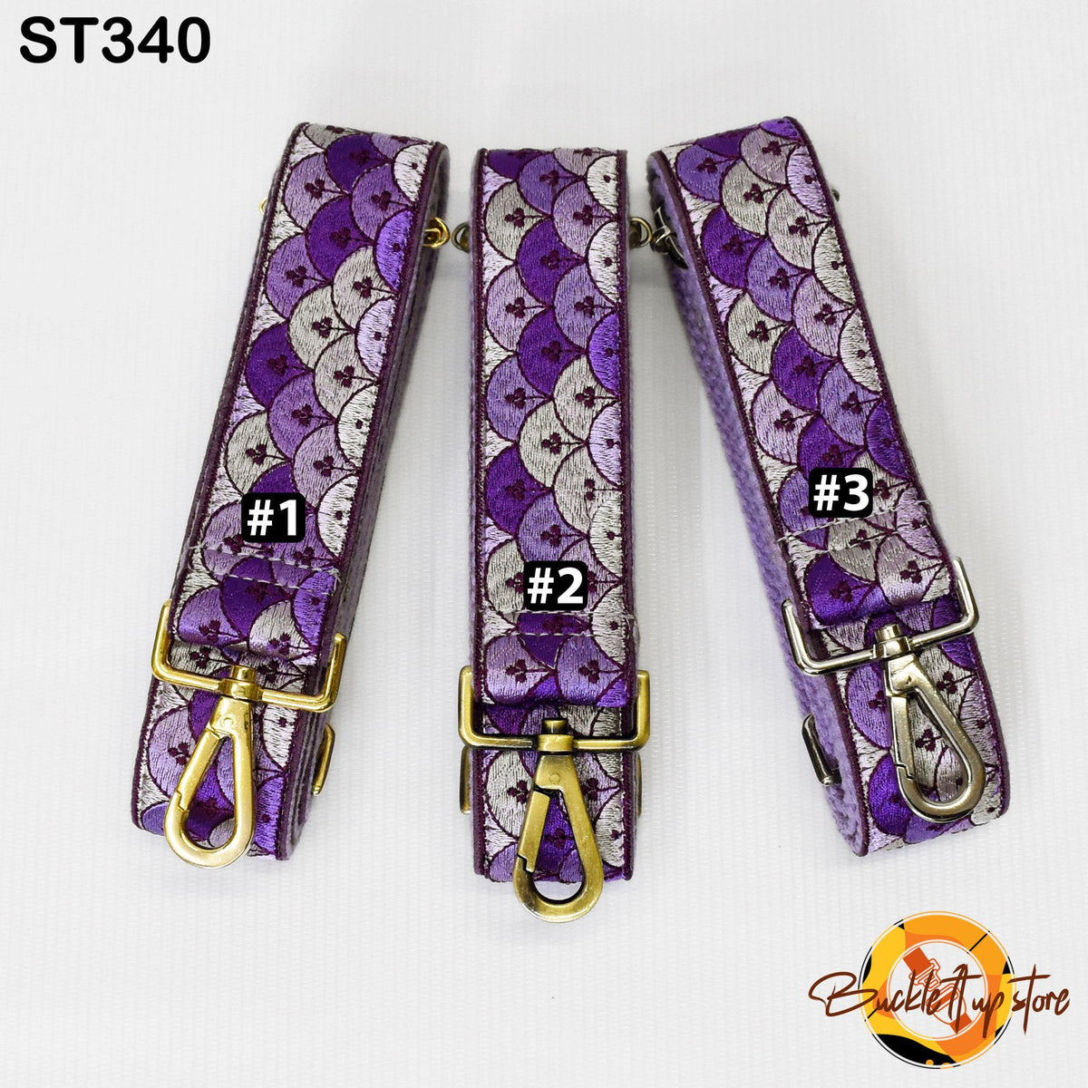 Three purple and white patterned straps with gold buckles, each with a number label.