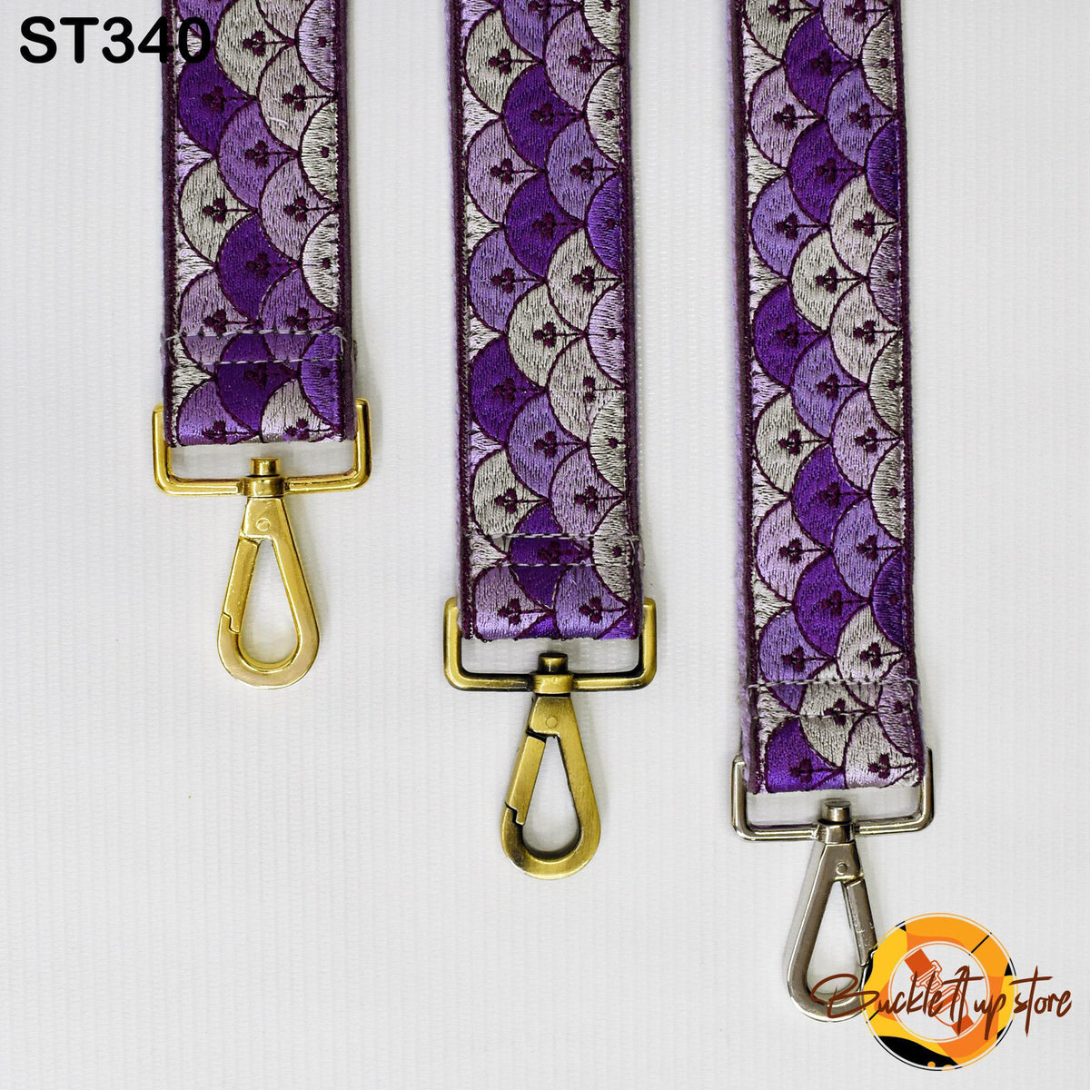 Three colorful straps with gold buckles, arranged in a row against a white background.