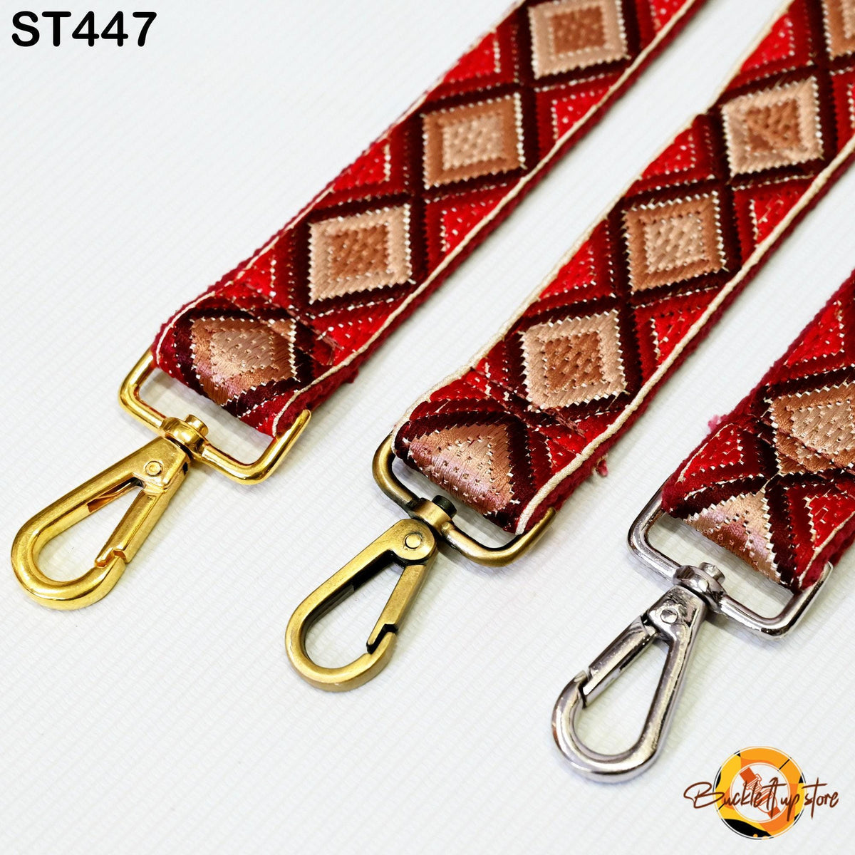 three colorful straps with gold and silver metal hooks, arranged side by side.